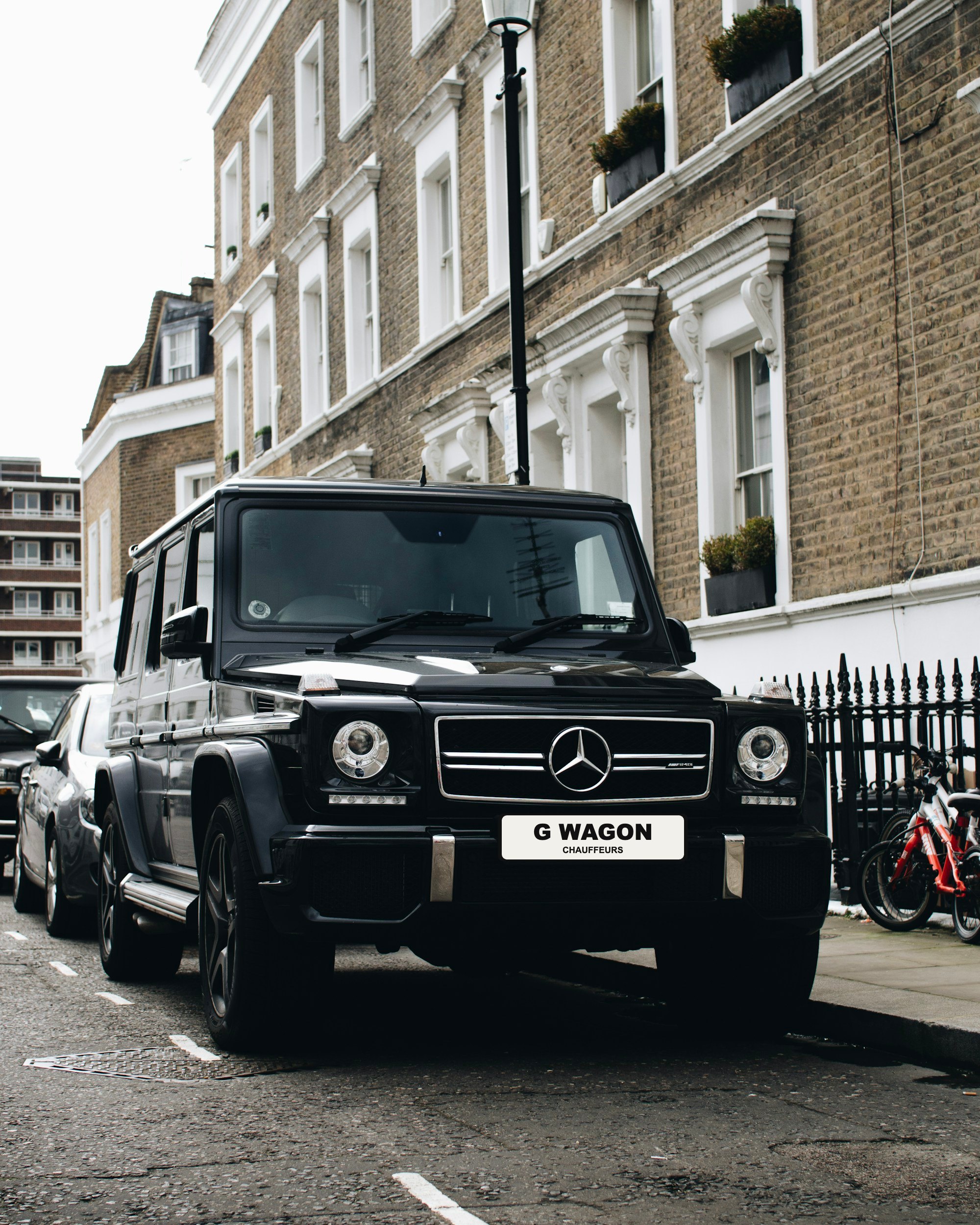 Black Mercedes G-Wagon with G Wagon Chauffeurs plate on a London street
